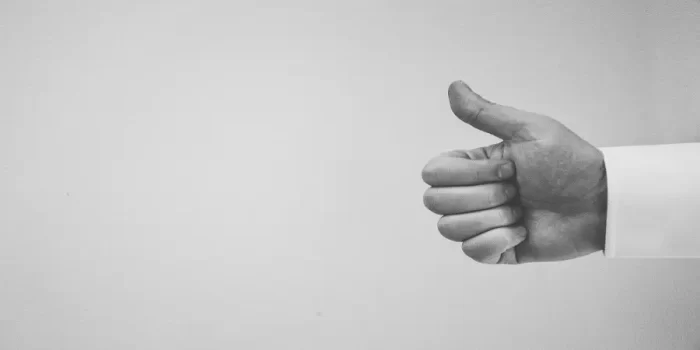 Black and white photo of a thumbs up.
